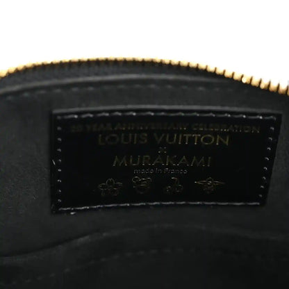 Louis Vuitton leather label inside black handbag with gold-toned zipper edge