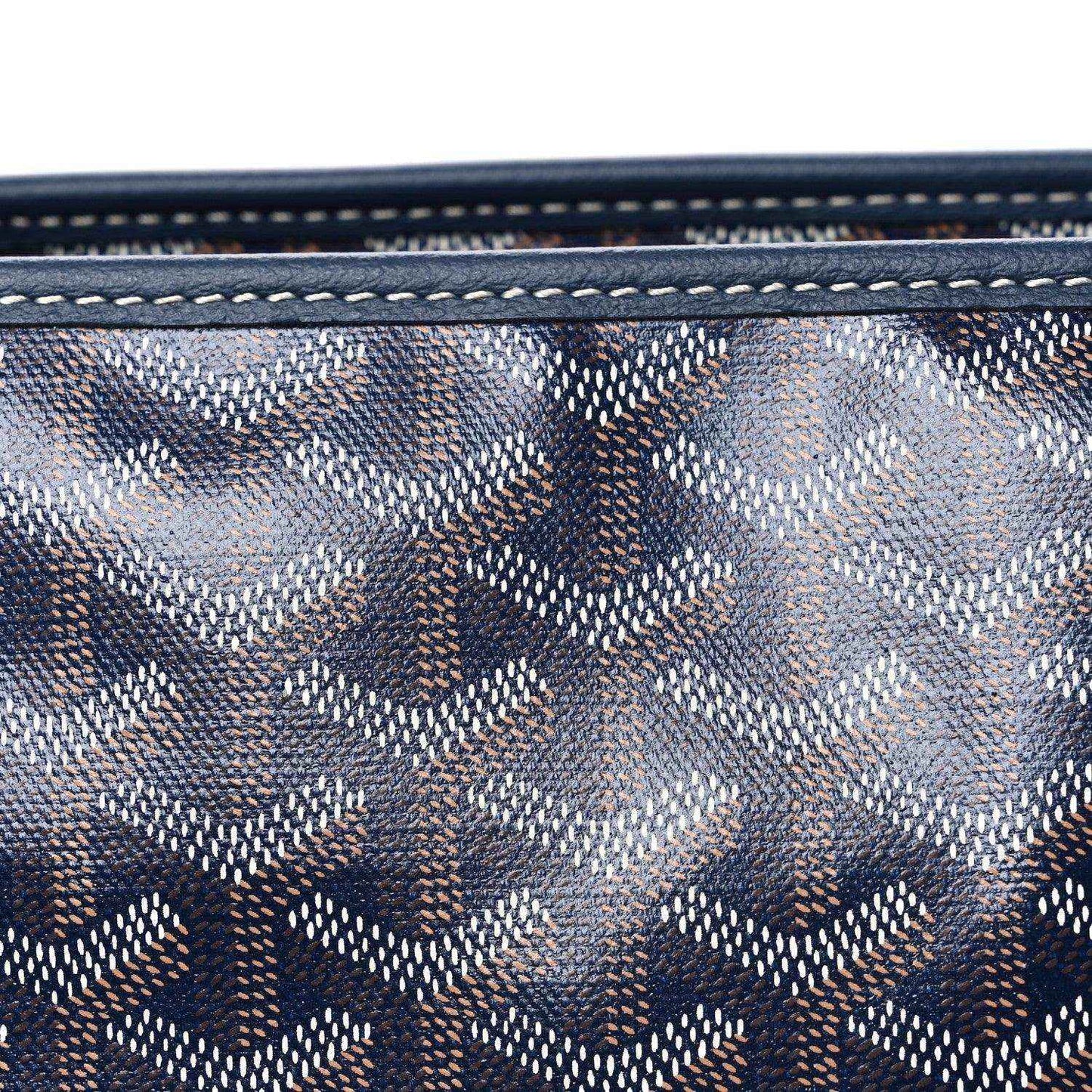 Close-up of navy Goyardine tote bag canvas with repeating logo pattern