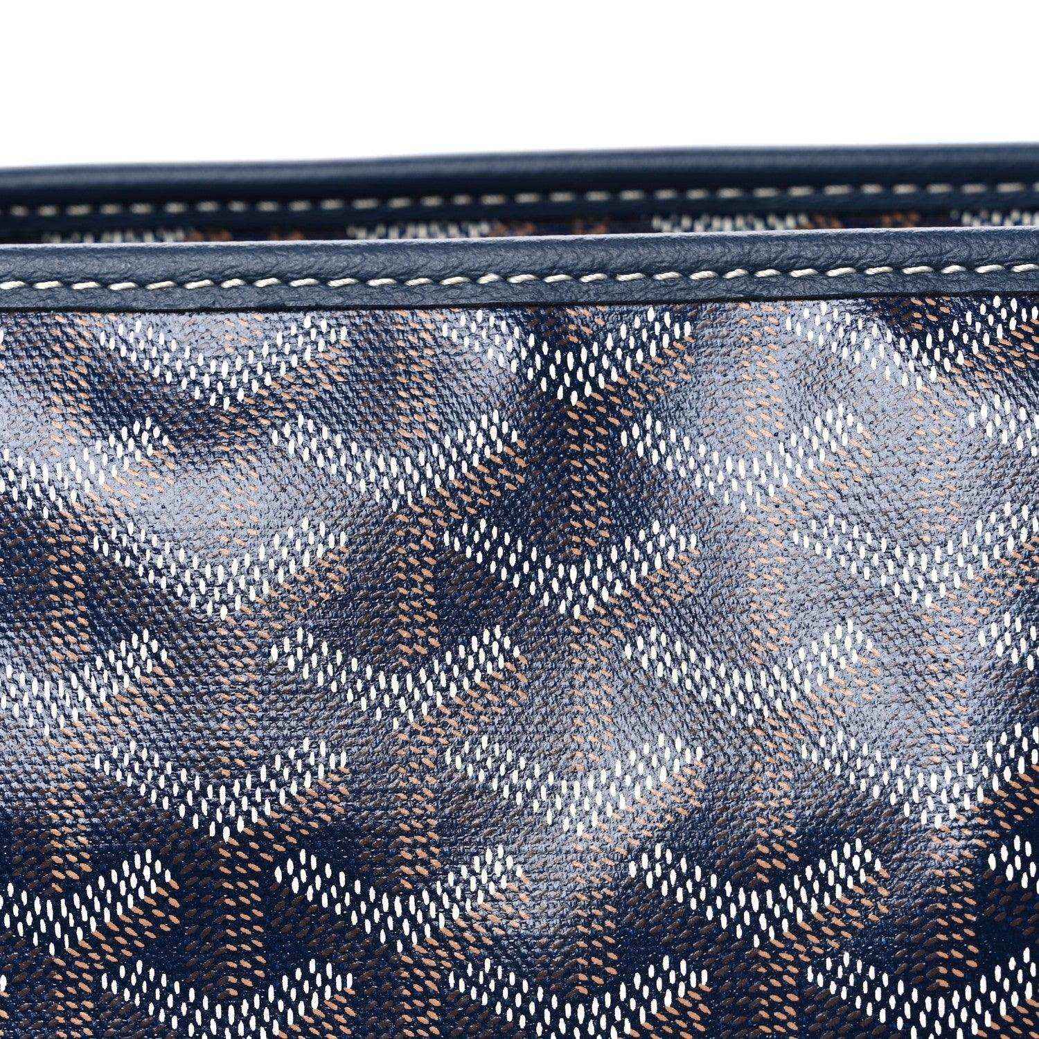 Close-up of navy Goyardine tote bag canvas with repeating logo pattern