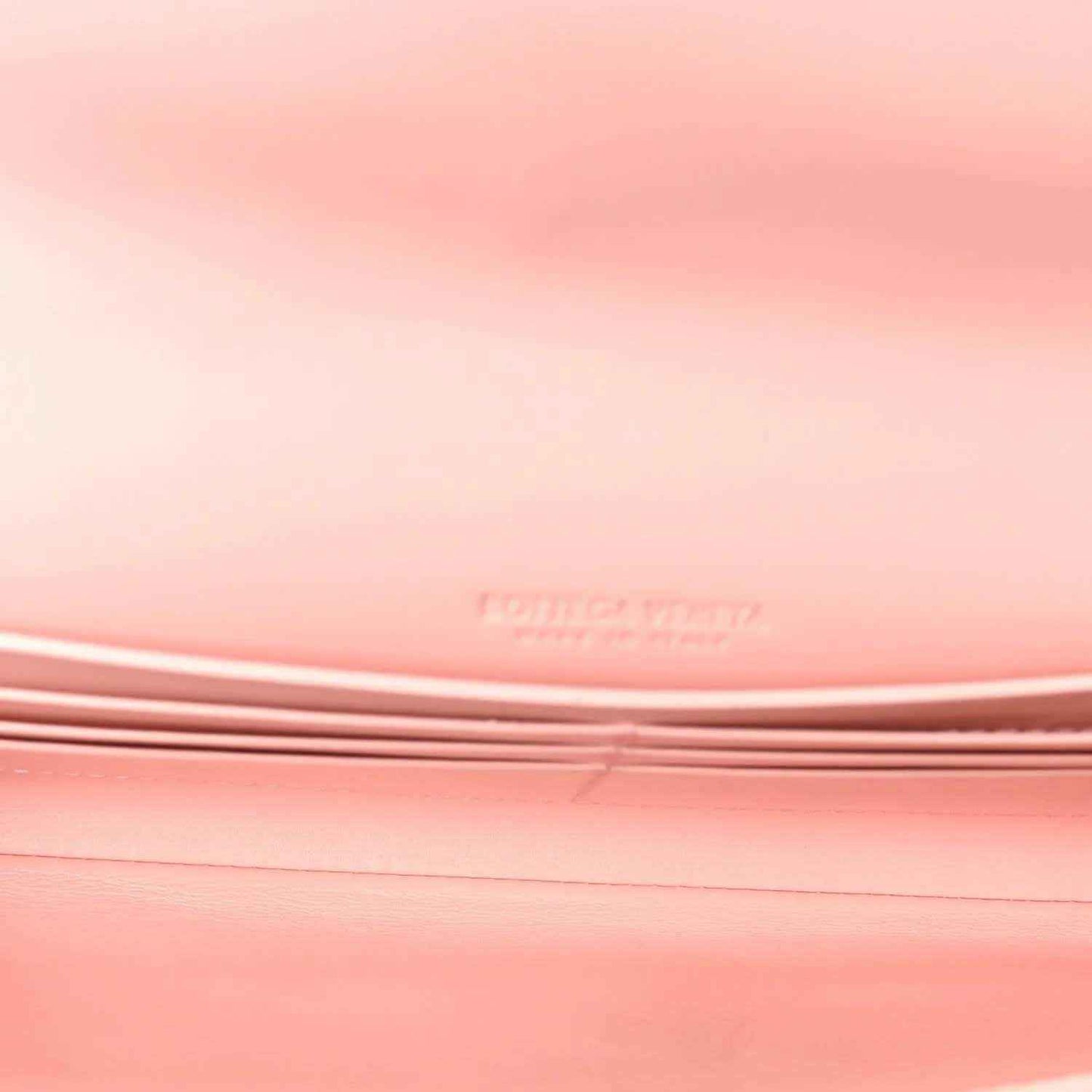 Rose pink nappa leather clutch surface, stitched intrecciato weave detail