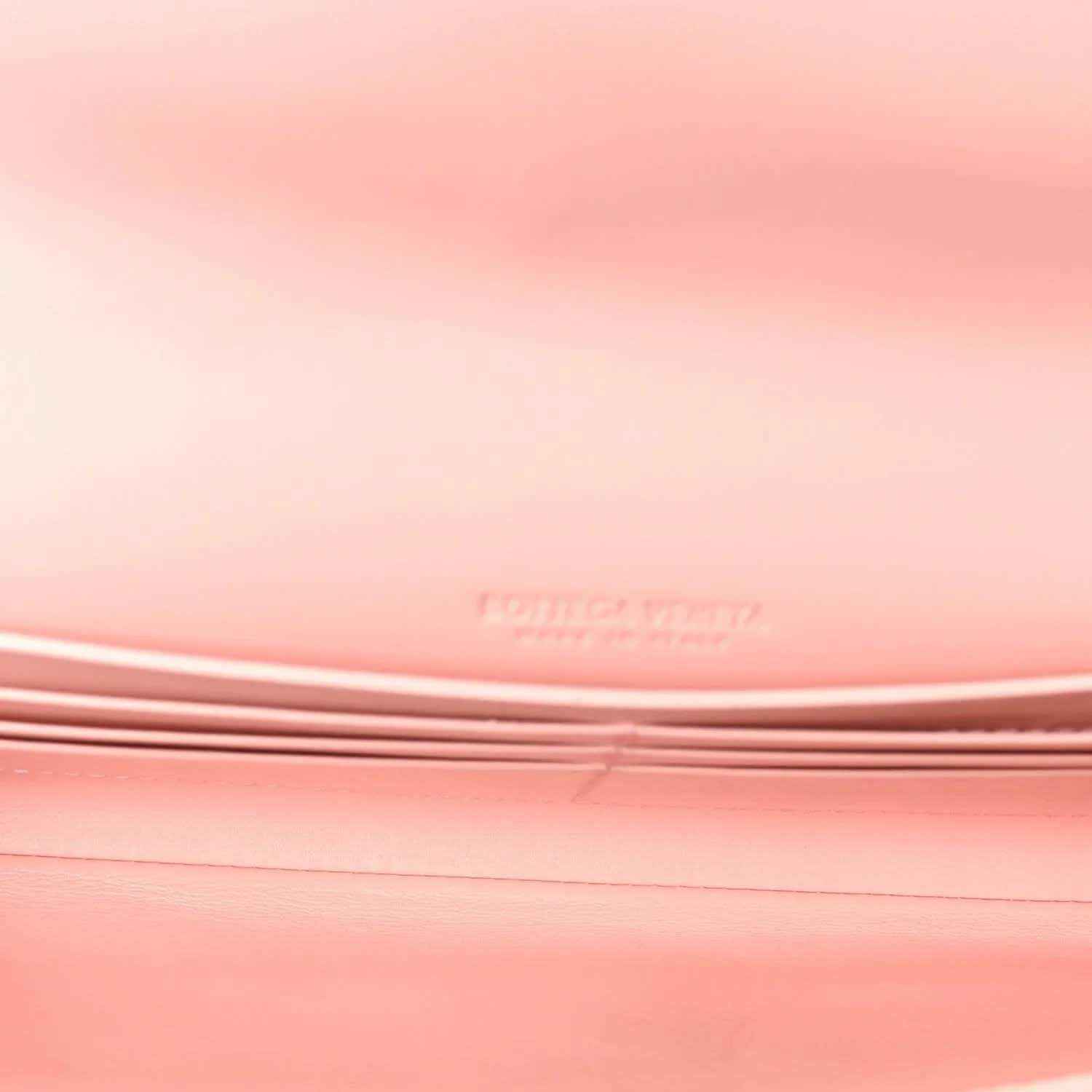 Rose pink nappa leather clutch surface, stitched intrecciato weave detail