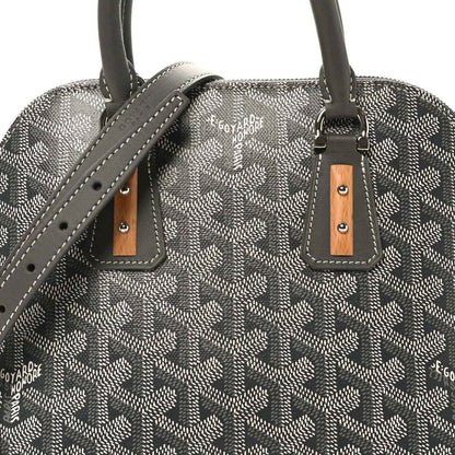 Grey coated canvas handbag with leather handle straps and brown pull tabs.