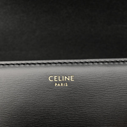 Black leather bag lining with 'CELINE PARIS' embossed text and stitched edge.