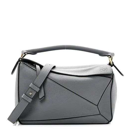Small puzzle bag in dark gray soft grained leather with top handle and shoulder strap
