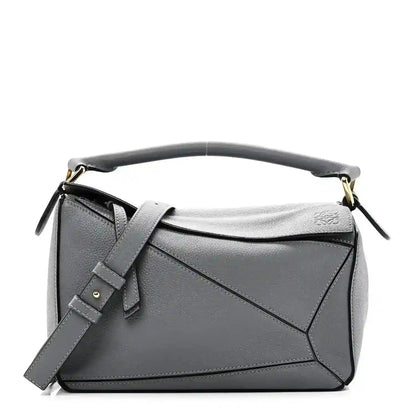 Small puzzle bag in dark gray soft grained leather with top handle and shoulder strap