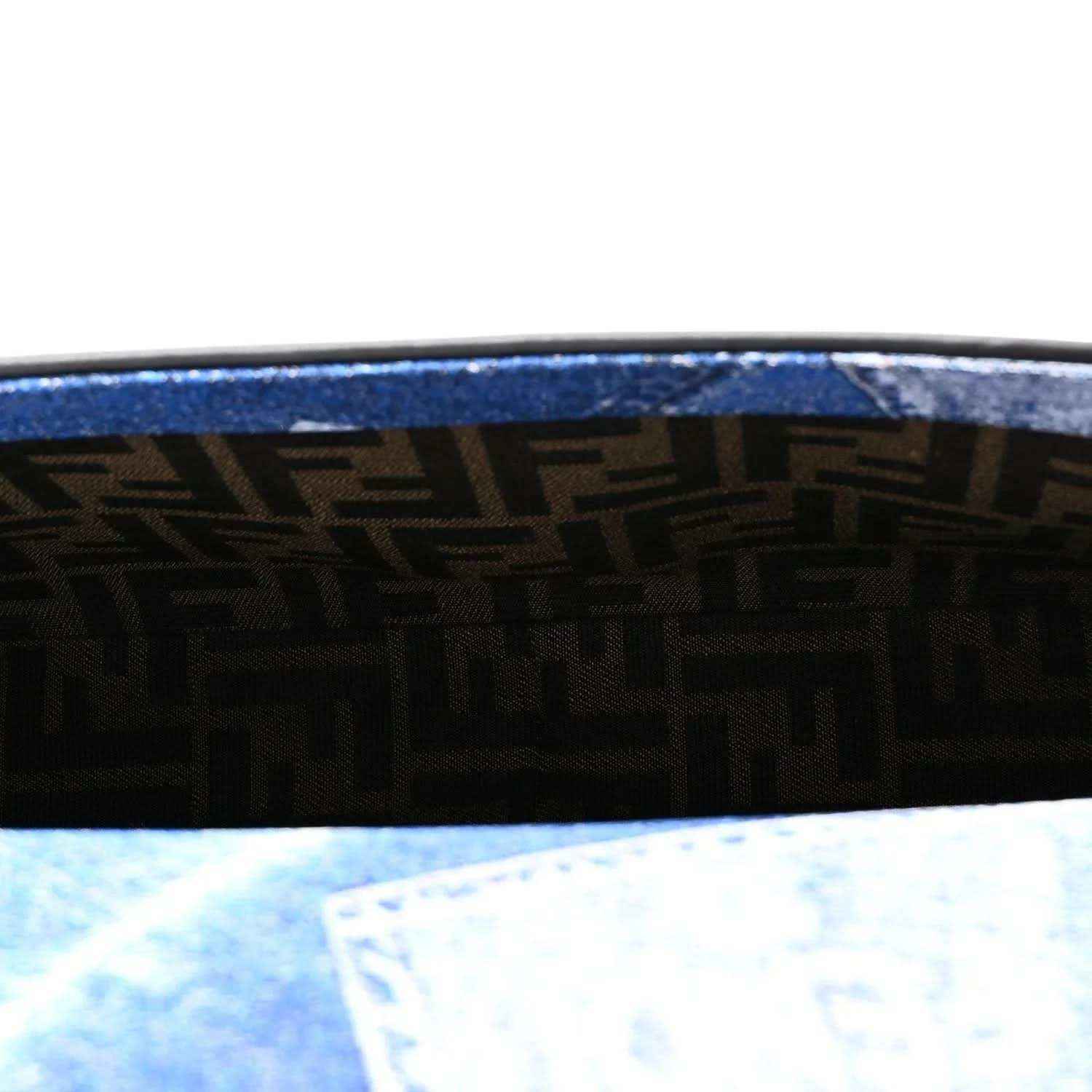 Close view of blue denim side panel with woven pattern and black trim border