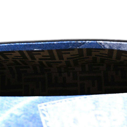 Close view of blue denim side panel with woven pattern and black trim border