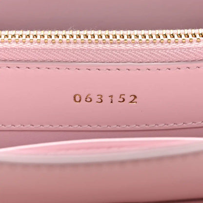 Pastel pink mini bag interior with gold zipper and stamped code 063152