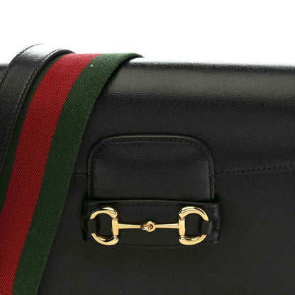 Black calfskin mini bag front with red and green web stripe and gold horsebit clasp