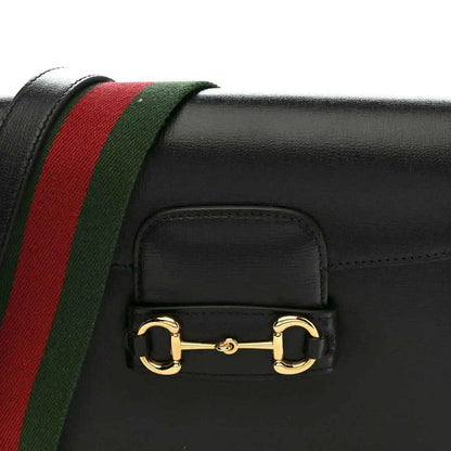 Black calfskin mini bag front with red and green web stripe and gold horsebit clasp