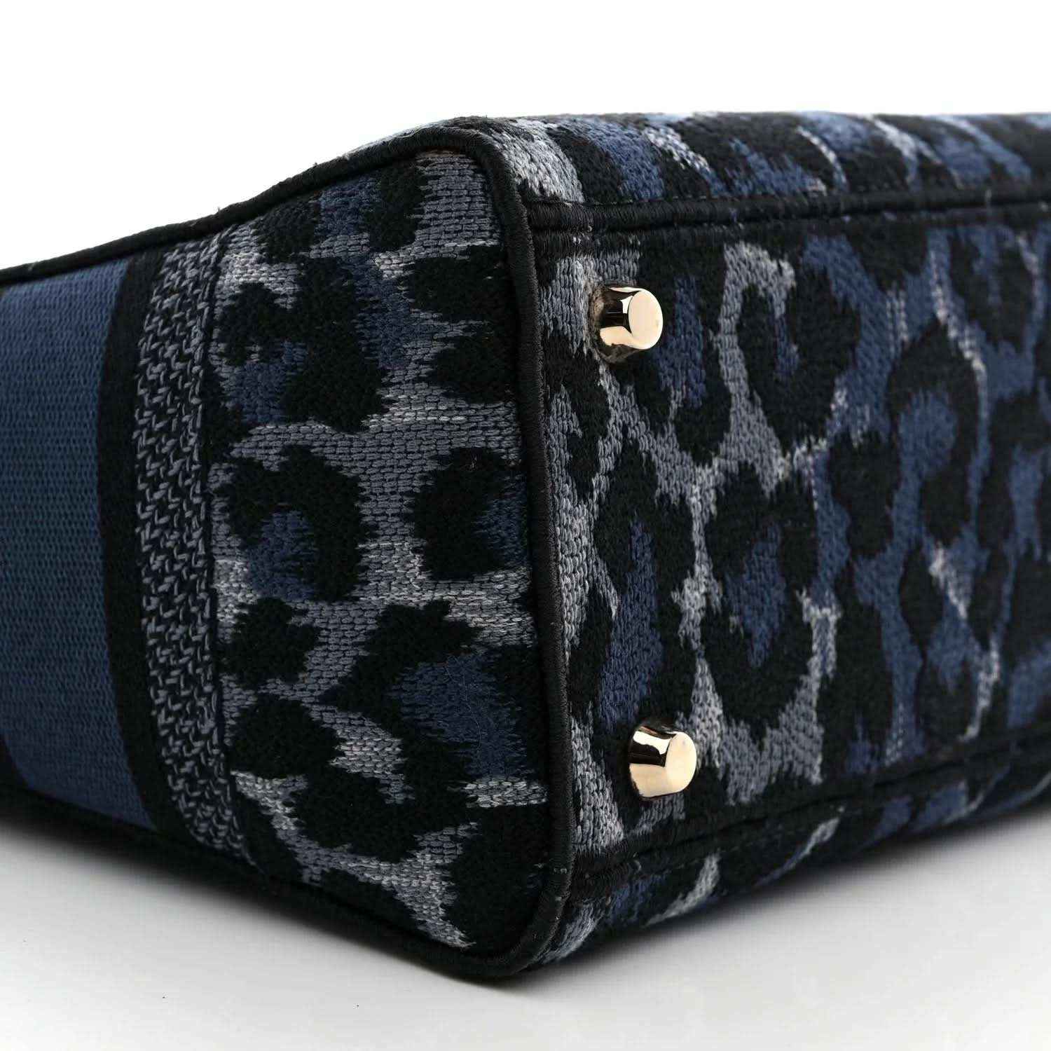 Christian Dior handbag bottom corner with leopard canvas and gold snap studs