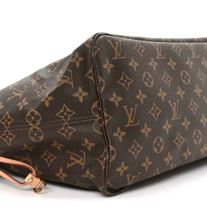 Monogram tote bag corner with brown patterned canvas and pink strap hardware