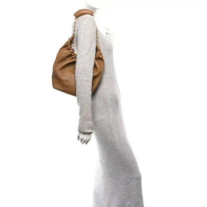 Loewe nappa small squeeze bag in oak-brown leather, side view with fuzzy lining