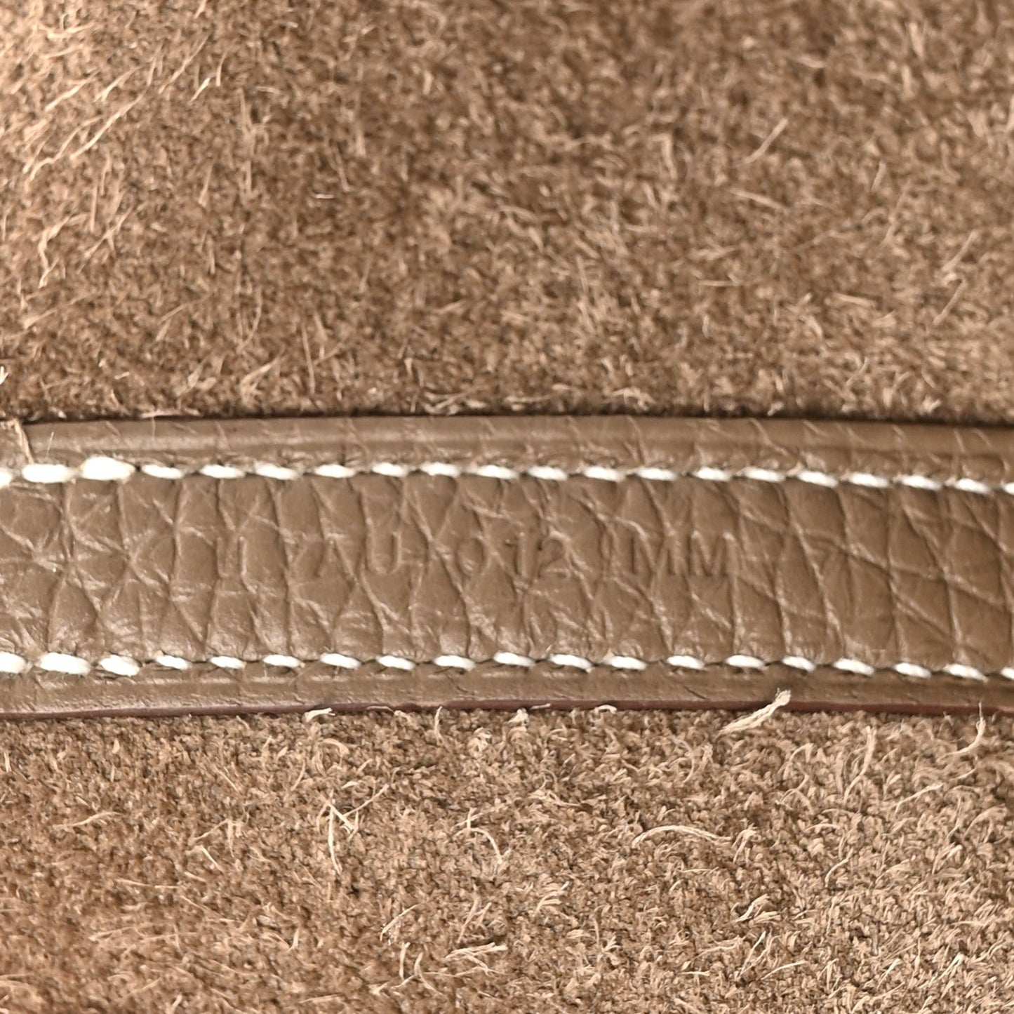 Leather trim with contrast topstitching along the bag opening