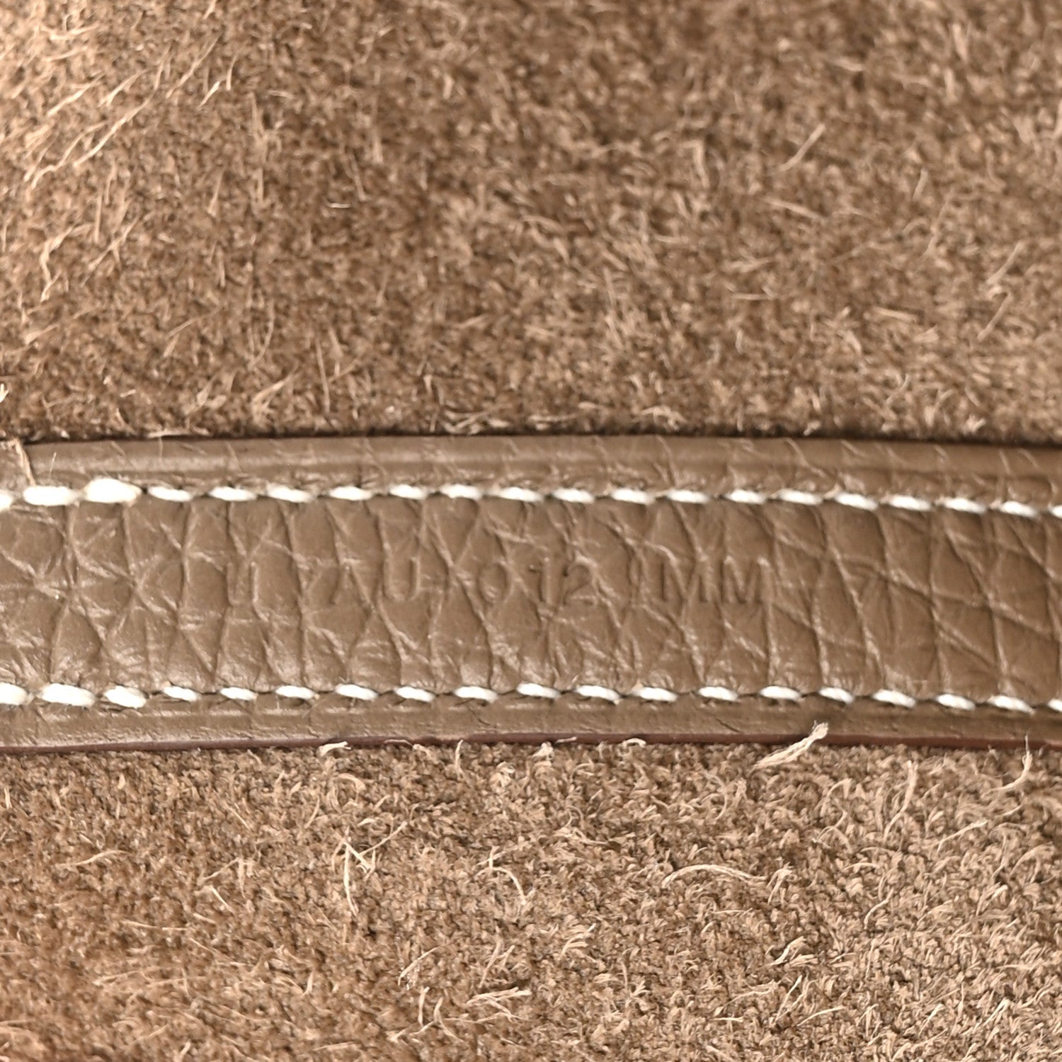 Leather trim with contrast topstitching along the bag opening