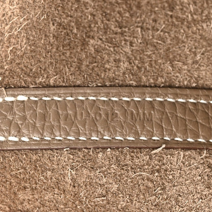 Leather trim with contrast topstitching along the bag opening