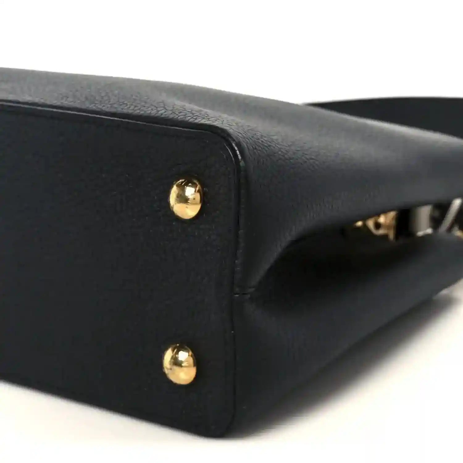 Black leather handbag corner with gold studs and side seam detail