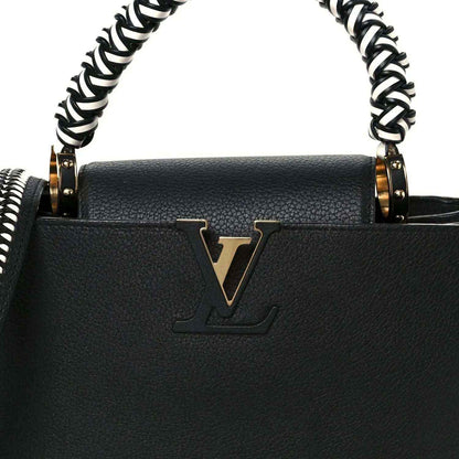 Black leather handbag front with gold LV emblem and braided chain handles