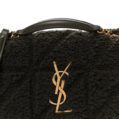 Saint Laurent shearling shoulder bag with gold YSL monogram emblem, close-up
