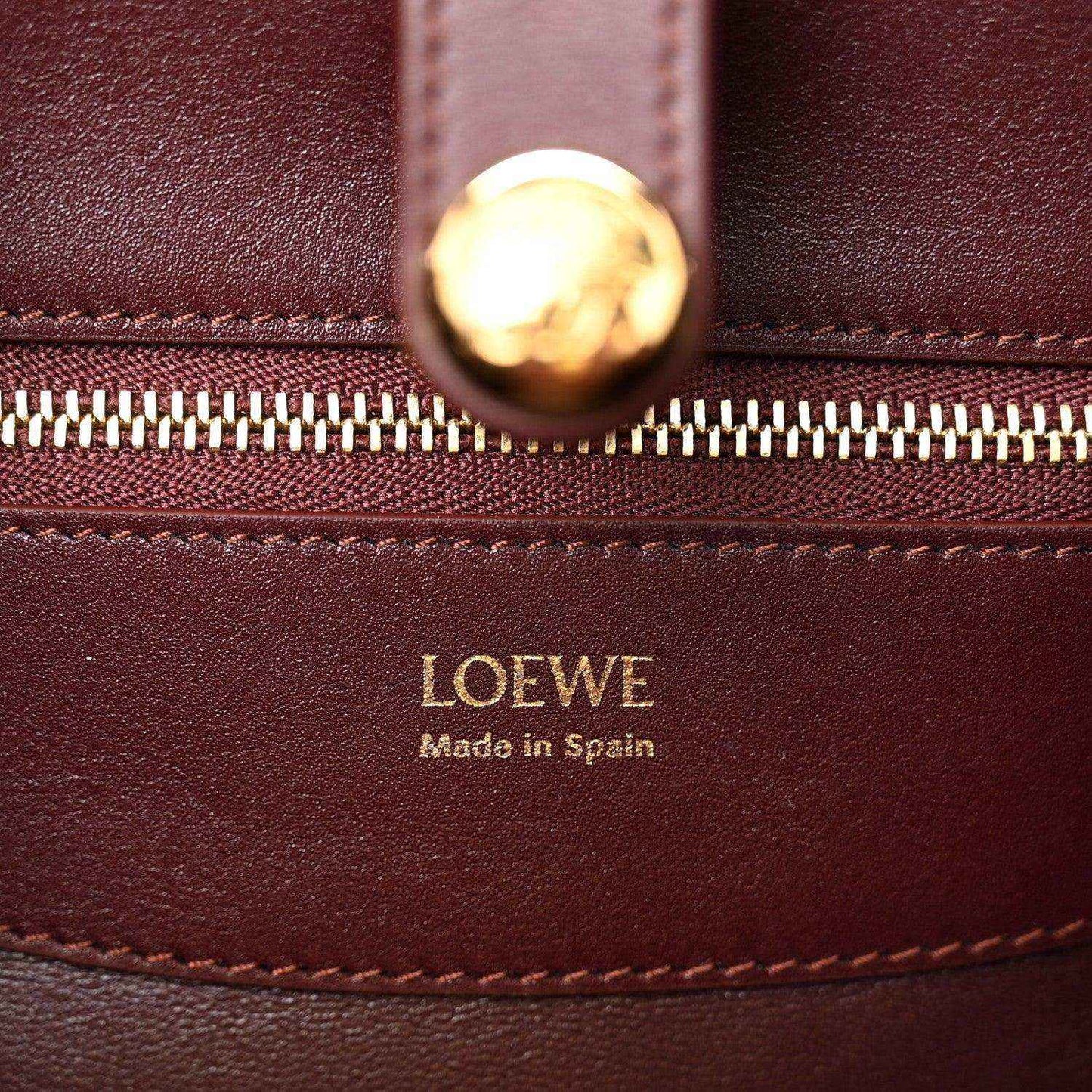 Loewe Small Madrid bag close-up: gold zipper pull and Loewe Made in Spain stamp