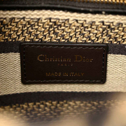 Christian Dior canvas bag label patch reading "Made in Italy"