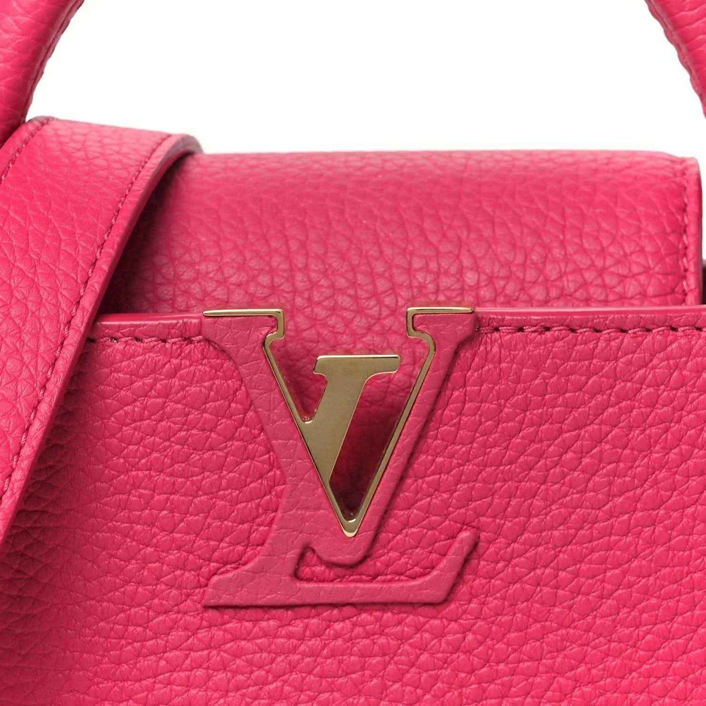 Magenta handbag front flap with gold LV logo, pebbled leather close-up