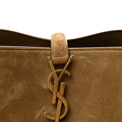 Suede bucket bag with YSL logo charm and top handle strap, golden tan