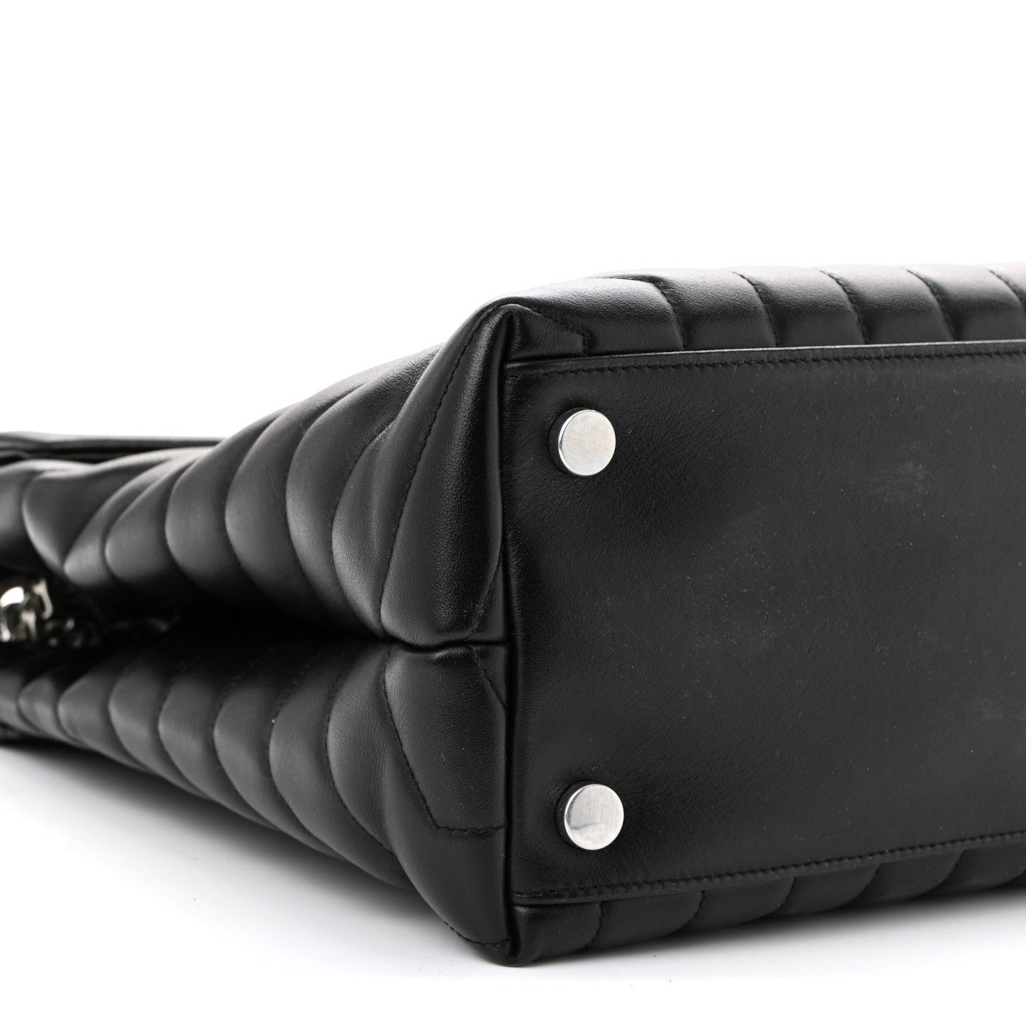 Black quilted leather satchel corner with two silver rivets