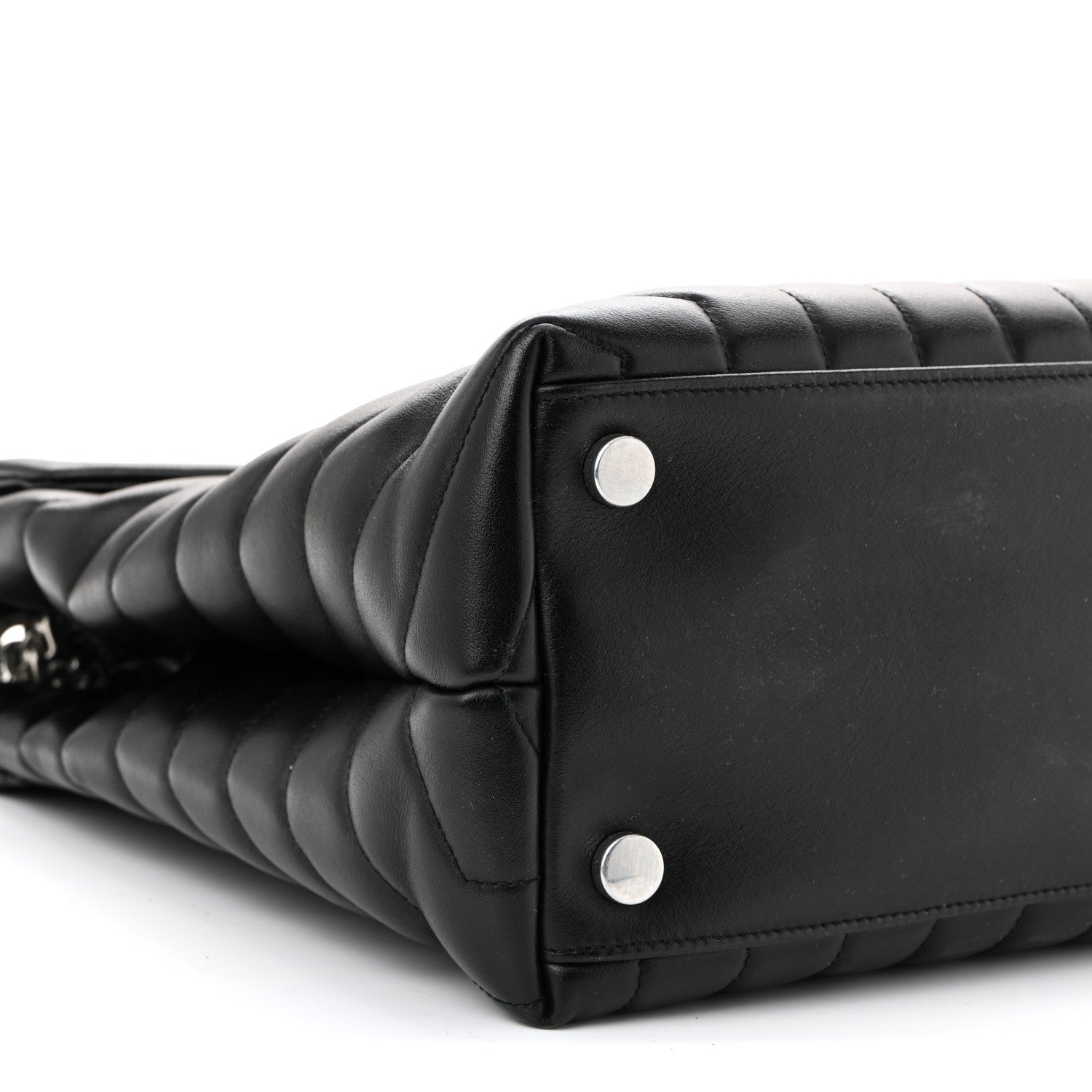 Black quilted leather satchel corner with two silver rivets