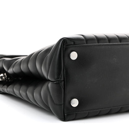 Black quilted leather satchel corner with two silver rivets
