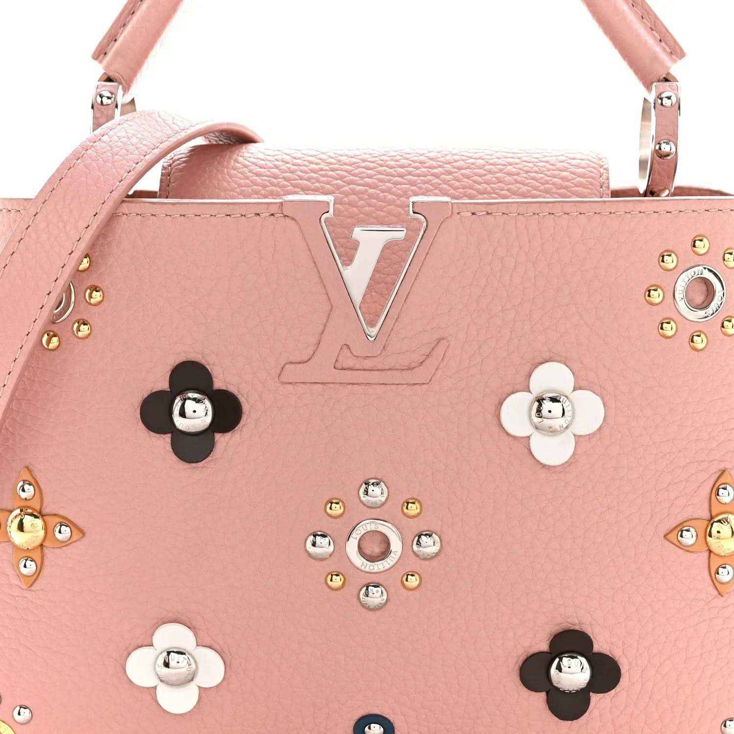 Pink leather handbag front with jeweled flower appliqués and twin top handles