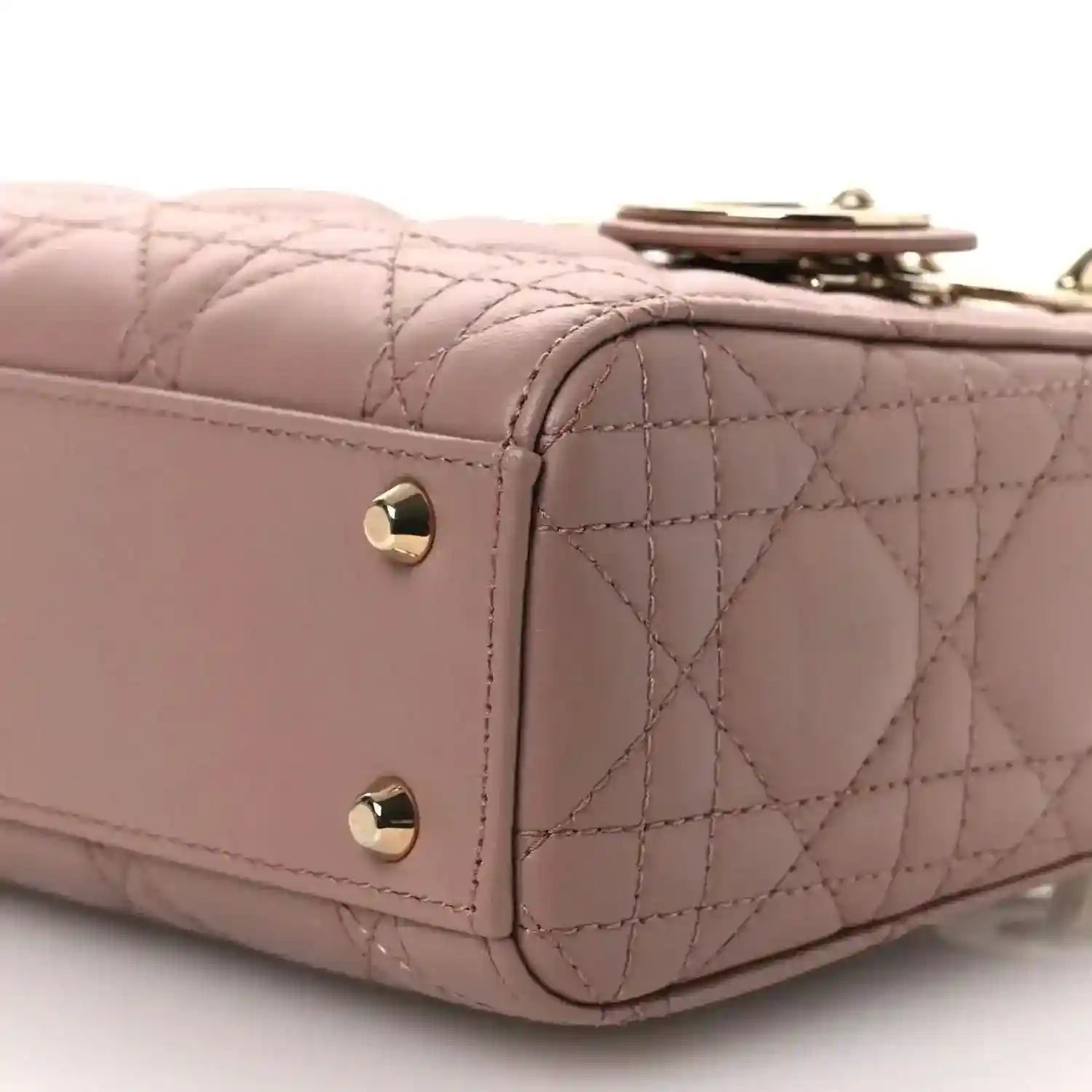 Mini Lady Dior handbag close-up of front flap and cannage quilting with gold-tone snaps.
