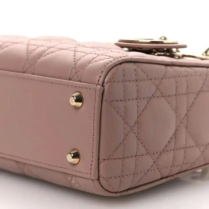 Mini Lady Dior handbag close-up of front flap and cannage quilting with gold-tone snaps.