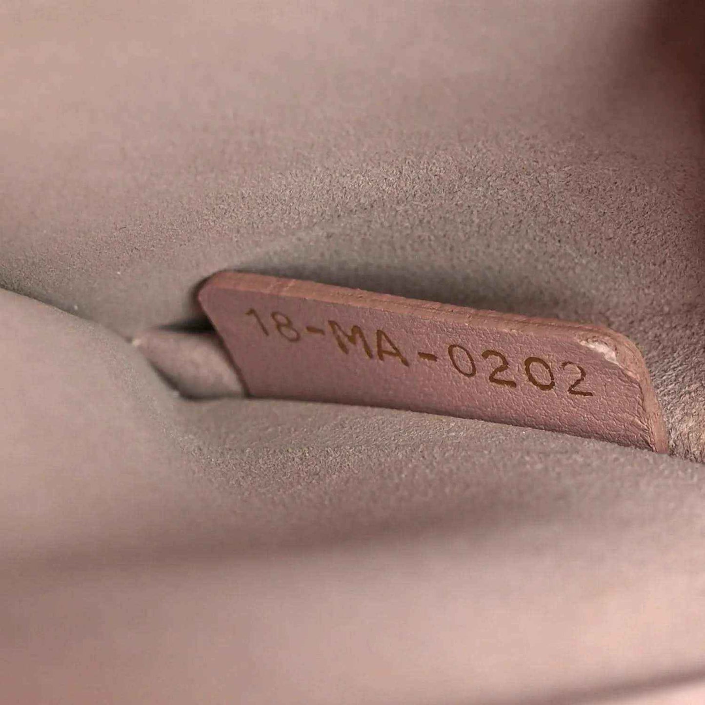 Lambskin handbag interior stamp reading 18-MA-02 2022 on pale pink lining