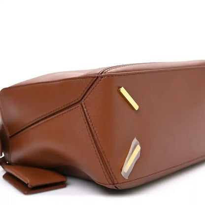 Pecan brown leather Puzzle bag with gold-tone bar detail and stitched front panel