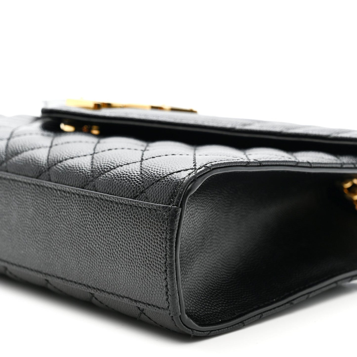 Black quilted satchel side view with leather edge and gold chain hardware