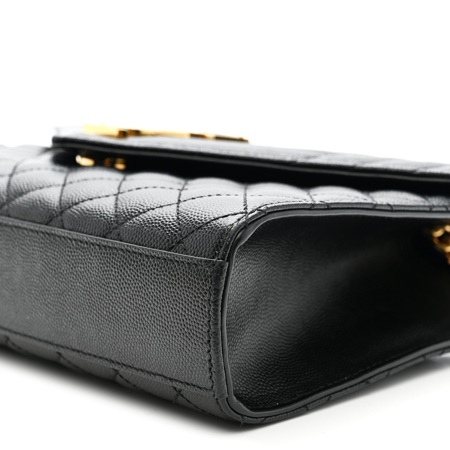 Black quilted satchel side view with leather edge and gold chain hardware