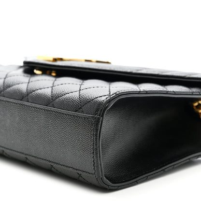Black quilted satchel side view with leather edge and gold chain hardware