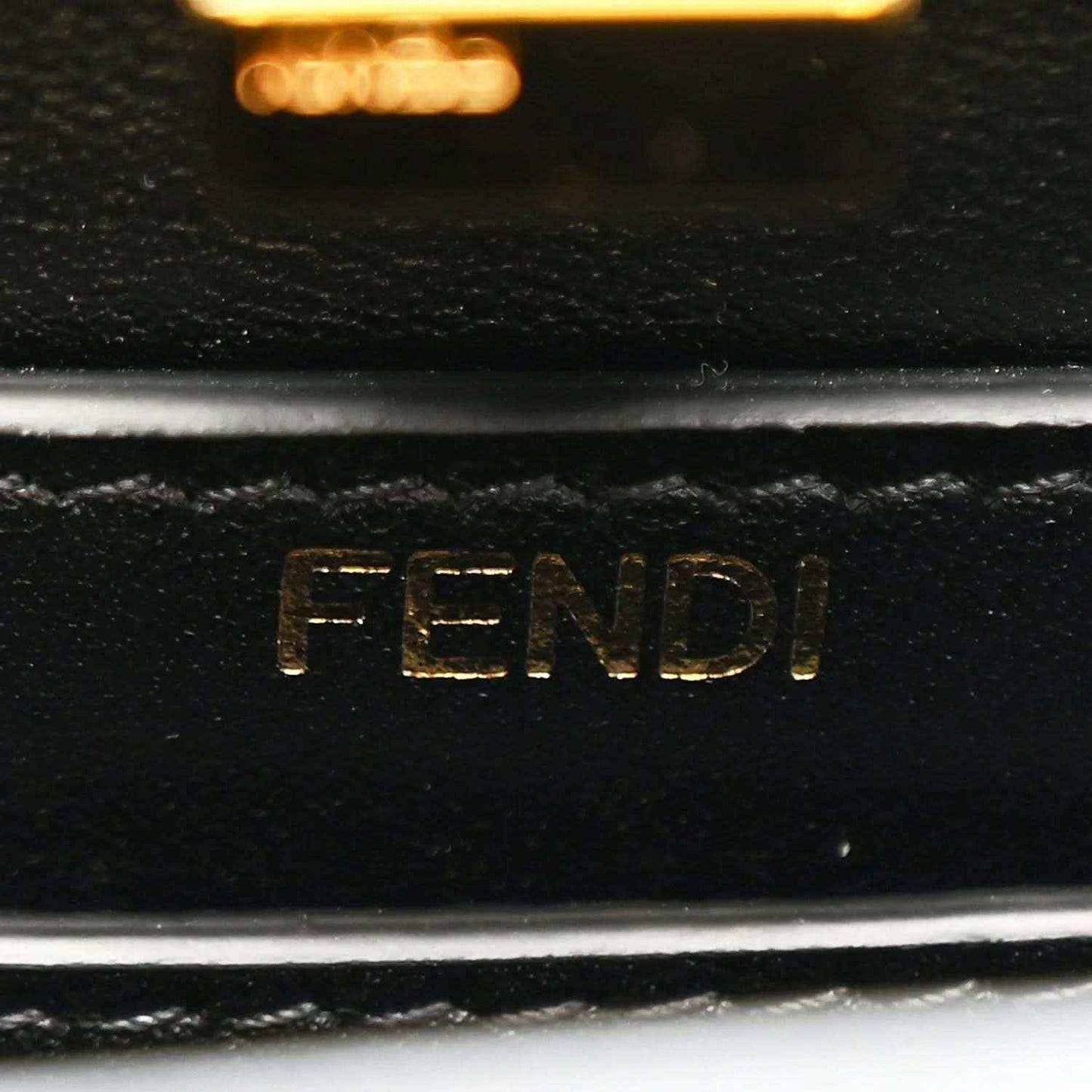 Black leather satchel with embossed FENDI logo on interior