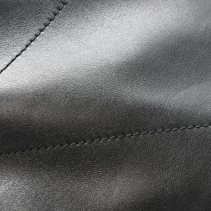 Black leather bag panel with fine grain texture and contrast stitching