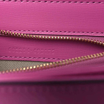 Gucci pink bag interior close-up of gold zipper and stitched inner pocket