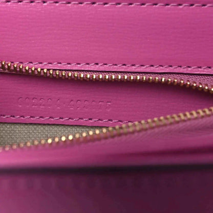 Gucci pink bag interior close-up of gold zipper and stitched inner pocket