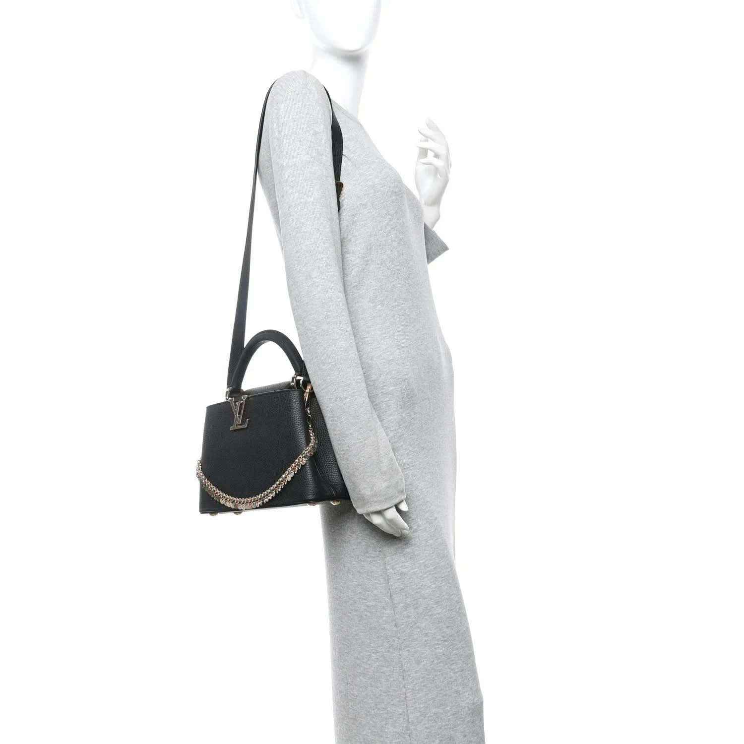 Black leather handbag with top handle, gold chain strap, and small LV emblem