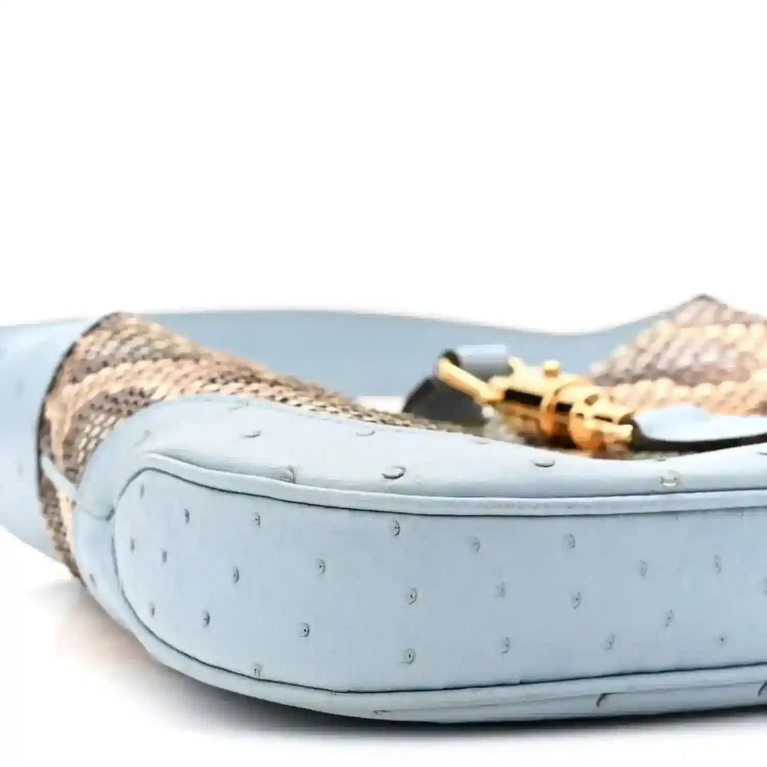 Small hobo bag bottom corner with light blue exterior and snakeskin side panel
