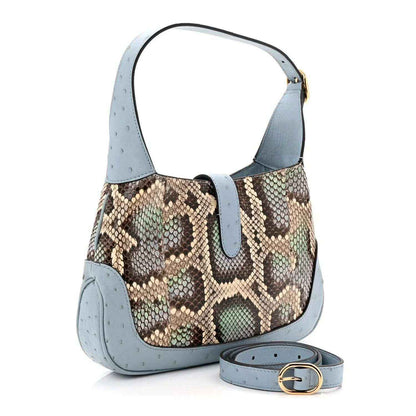 Small hobo bag with snakeskin front, light blue leather trim, and detachable strap