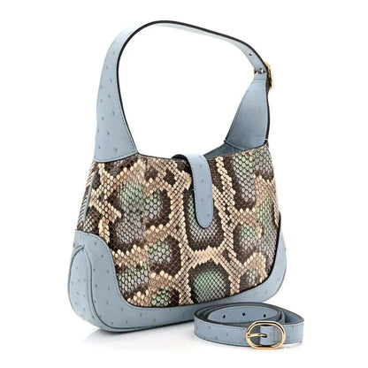 Small hobo bag with snakeskin front, light blue leather trim, and detachable strap