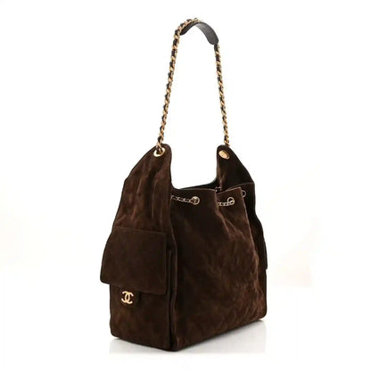 Dark brown suede quilted handbag with top chain handles and front CC logo