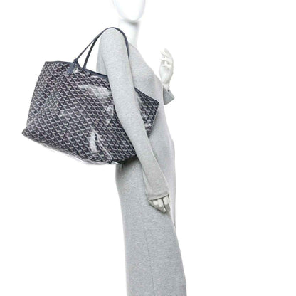 Navy patterned tote bag shown in side view with top handles and open silhouette.