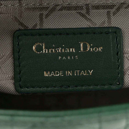 Green leather logo patch reading Christian Dior Paris, made in Italy