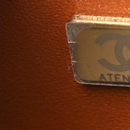 Caramel leather bag corner with protective label covering the edge